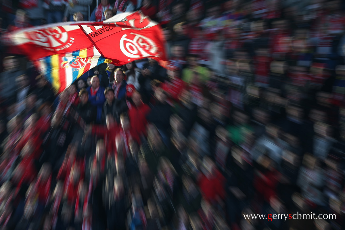 Fans of FSV Mainz 05 showing their Flag in the setting sunlight