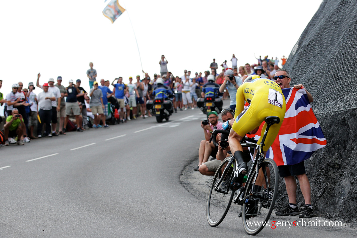 Chris Froome is pushed by a fan during time trials at Chorges