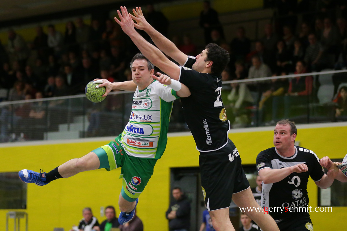 Vlado Sarac challenges Nenad Malencic during the game HB Berchem - HB Esch