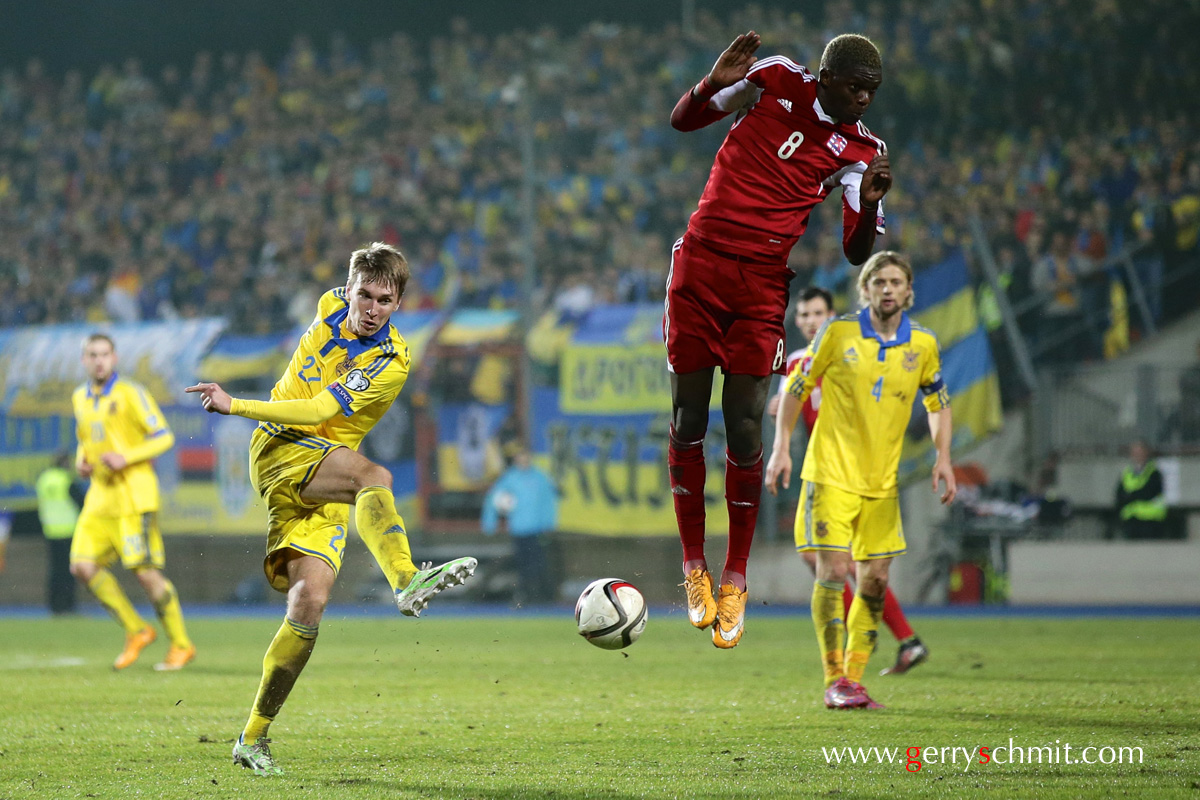 Christopher Martins of Luxembourg tries to block a shot from Serhiy Sydorchuk during EM Qualifying game